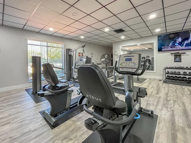 a room with gym equipment and a large window