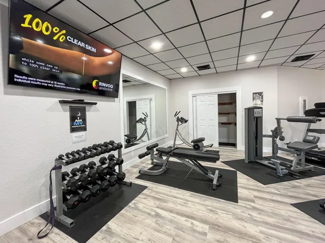 an aerial view of residential house with outdoor space and trees all around