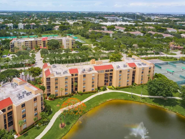 an aerial view of residential houses with outdoor space and lake view