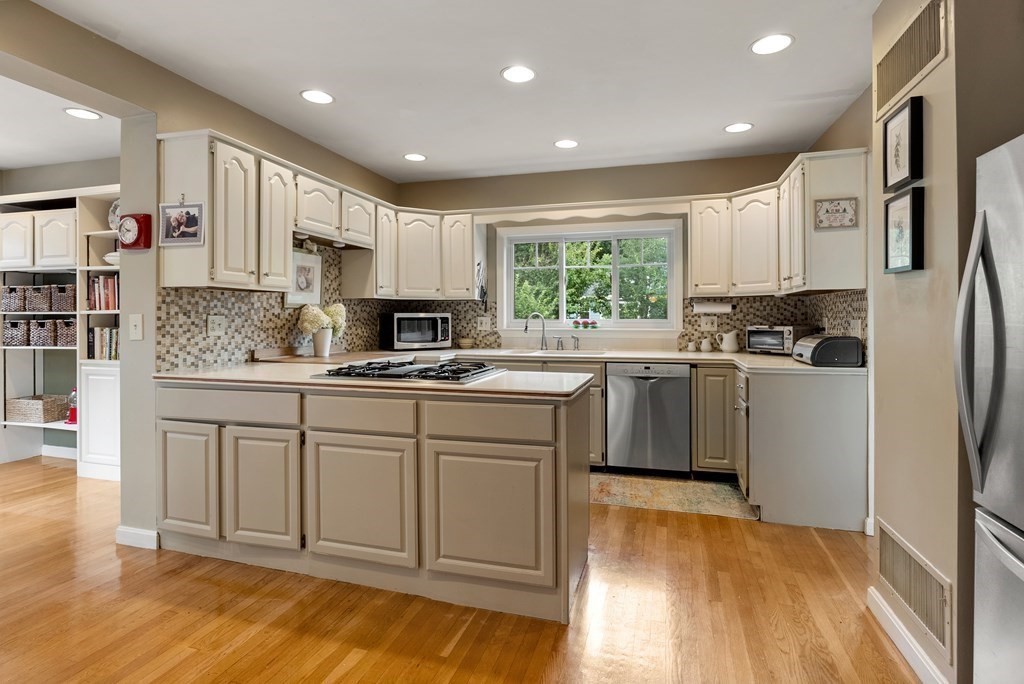 126 Chapman Street Canton, MA 02021 - Photo 17 of 42 a kitchen with white cabinets and appliances