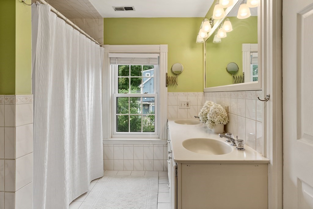126 Chapman Street Canton, MA 02021 - Photo 26 of 42 a bathroom with a sink a mirror and a shower