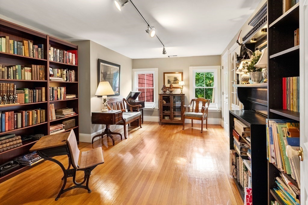 126 Chapman Street Canton, MA 02021 - Photo 8 of 42 a living room with fireplace furniture and a book shelf