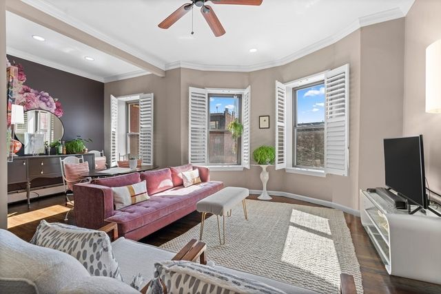 a living room with furniture a large window and a flat screen tv