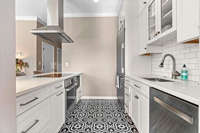 a kitchen with a sink stove and cabinets