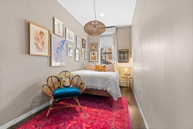 a bedroom with a bed and a chandelier