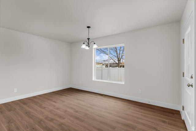 576 7th Avenue Midvale, UT 84047 - Photo 6 of 32 Unfurnished dining area with hanging lights and wood finished floors