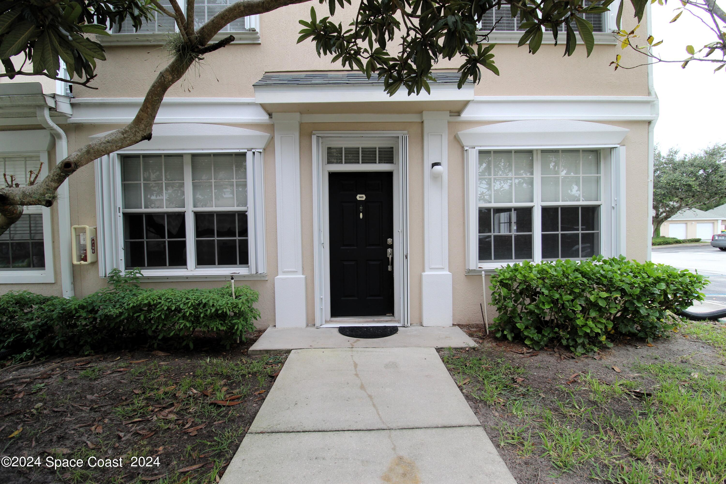 3975 Almeida Court, Unit 105 Melbourne, FL 32901 - Photo 1 of 18 a view of a building with potted plants