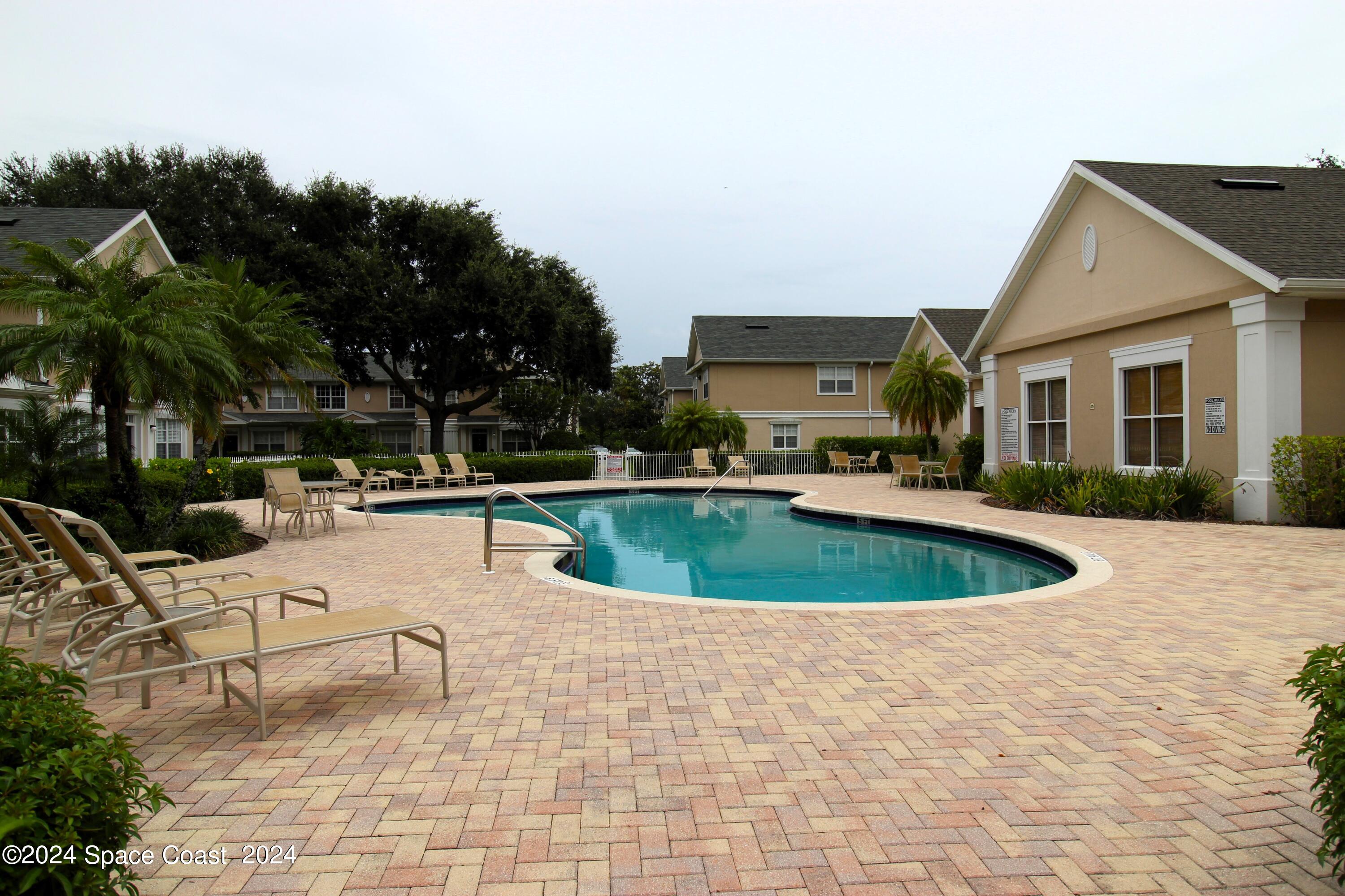 3975 Almeida Court, Unit 105 Melbourne, FL 32901 - Photo 16 of 18 a view of a house with swimming pool and sitting area