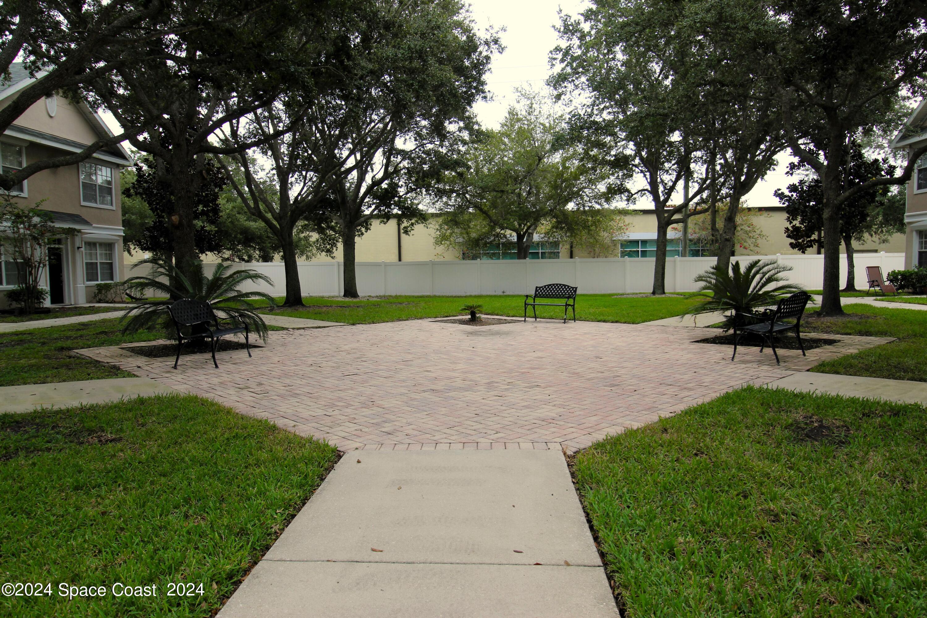 3975 Almeida Court, Unit 105 Melbourne, FL 32901 - Photo 17 of 18 a view of park with bench and trees