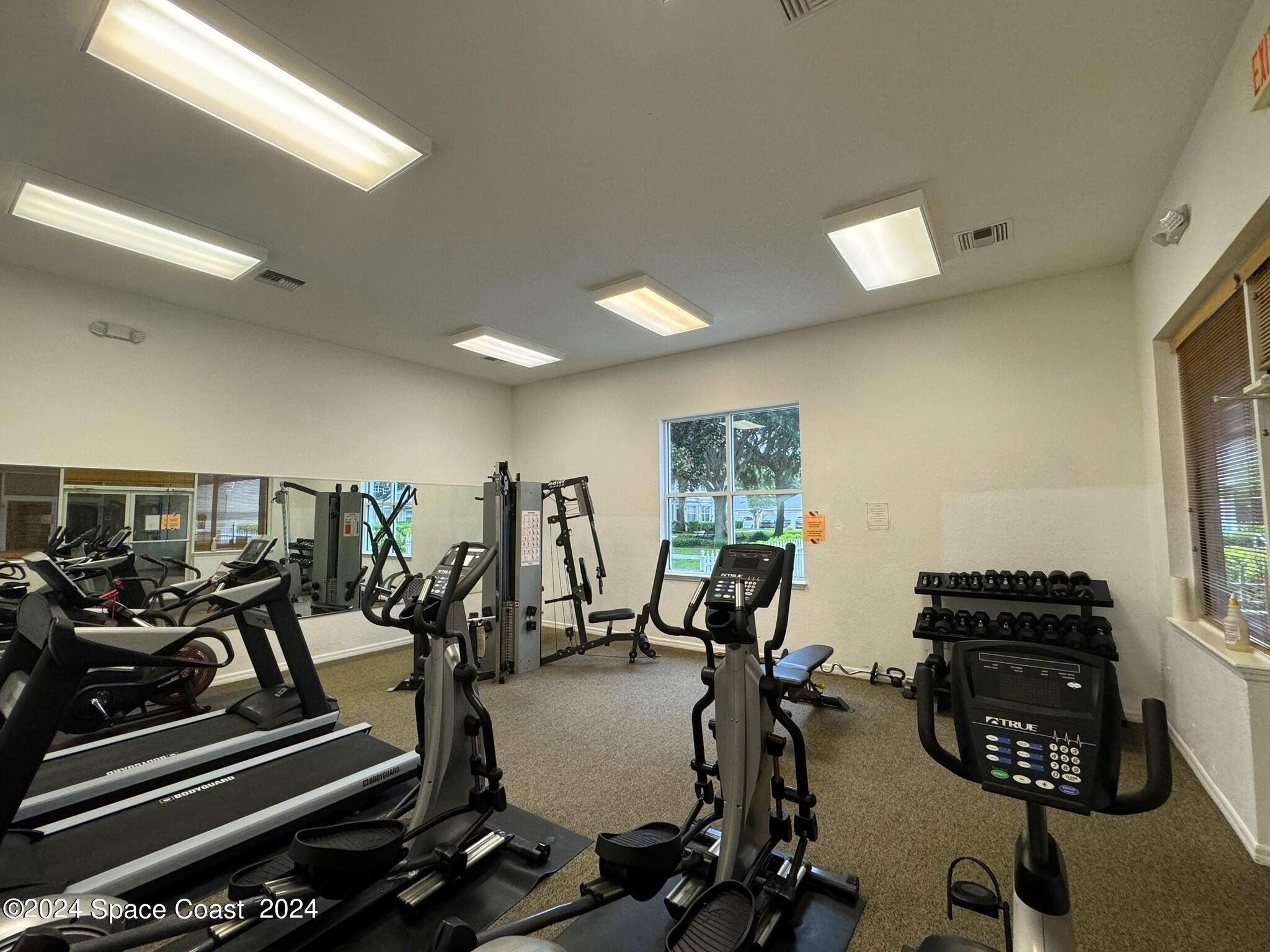 3975 Almeida Court, Unit 105 Melbourne, FL 32901 - Photo 18 of 18 a view of a room with gym equipment