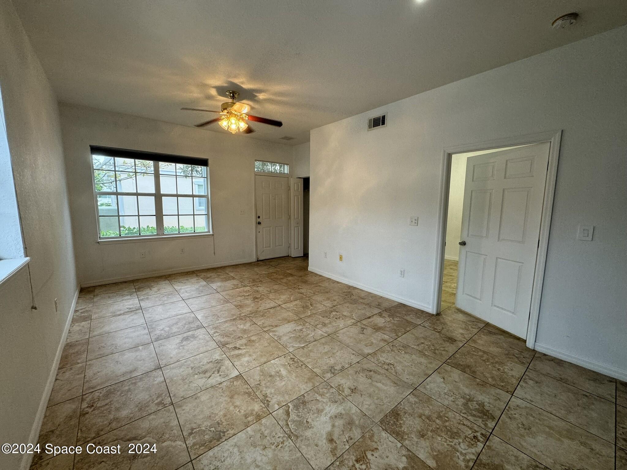 3975 Almeida Court, Unit 105 Melbourne, FL 32901 - Photo 2 of 18 a view of an empty room with a window