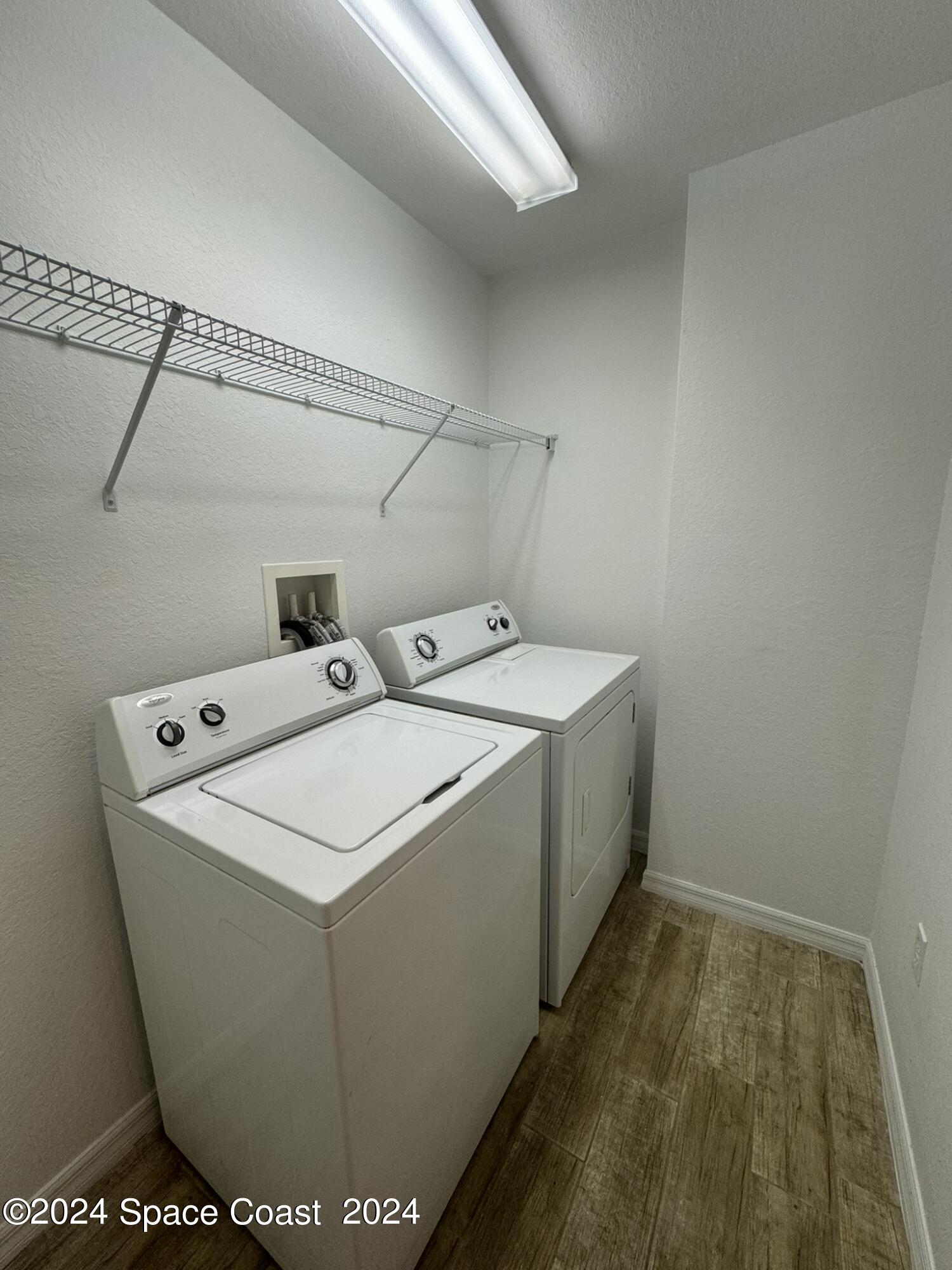 3975 Almeida Court, Unit 105 Melbourne, FL 32901 - Photo 8 of 18 a utility room with dryer and washer