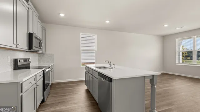 a view of a hallway with wooden floor and closet