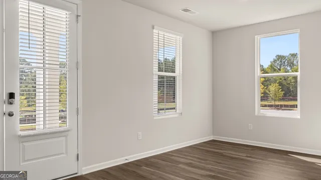 a kitchen with granite countertop a stove a sink and a refrigerator