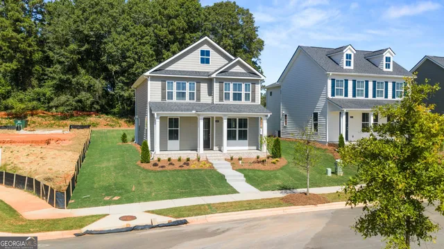 a kitchen with kitchen island granite countertop a sink cabinets and wooden floor