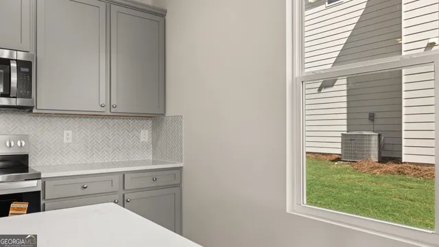 a kitchen with a sink cabinets and wooden floor