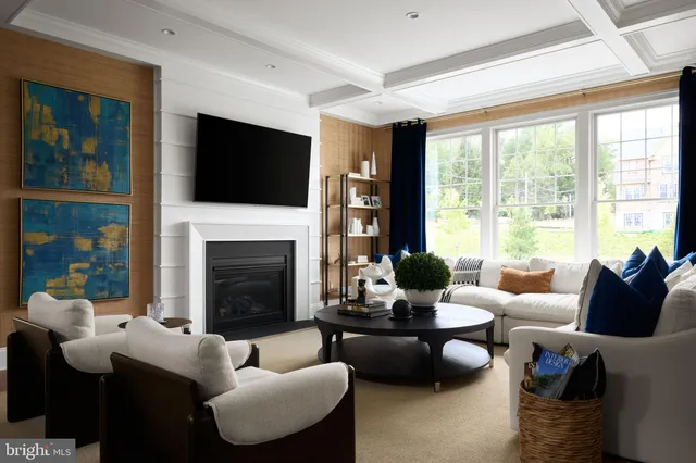 a living room with furniture a large window and a fireplace