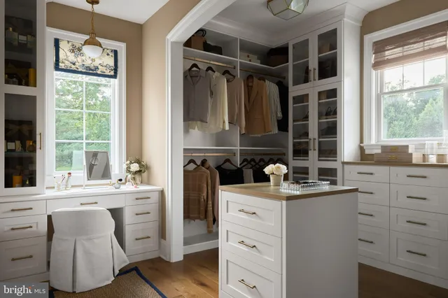a kitchen with a sink window and cabinets