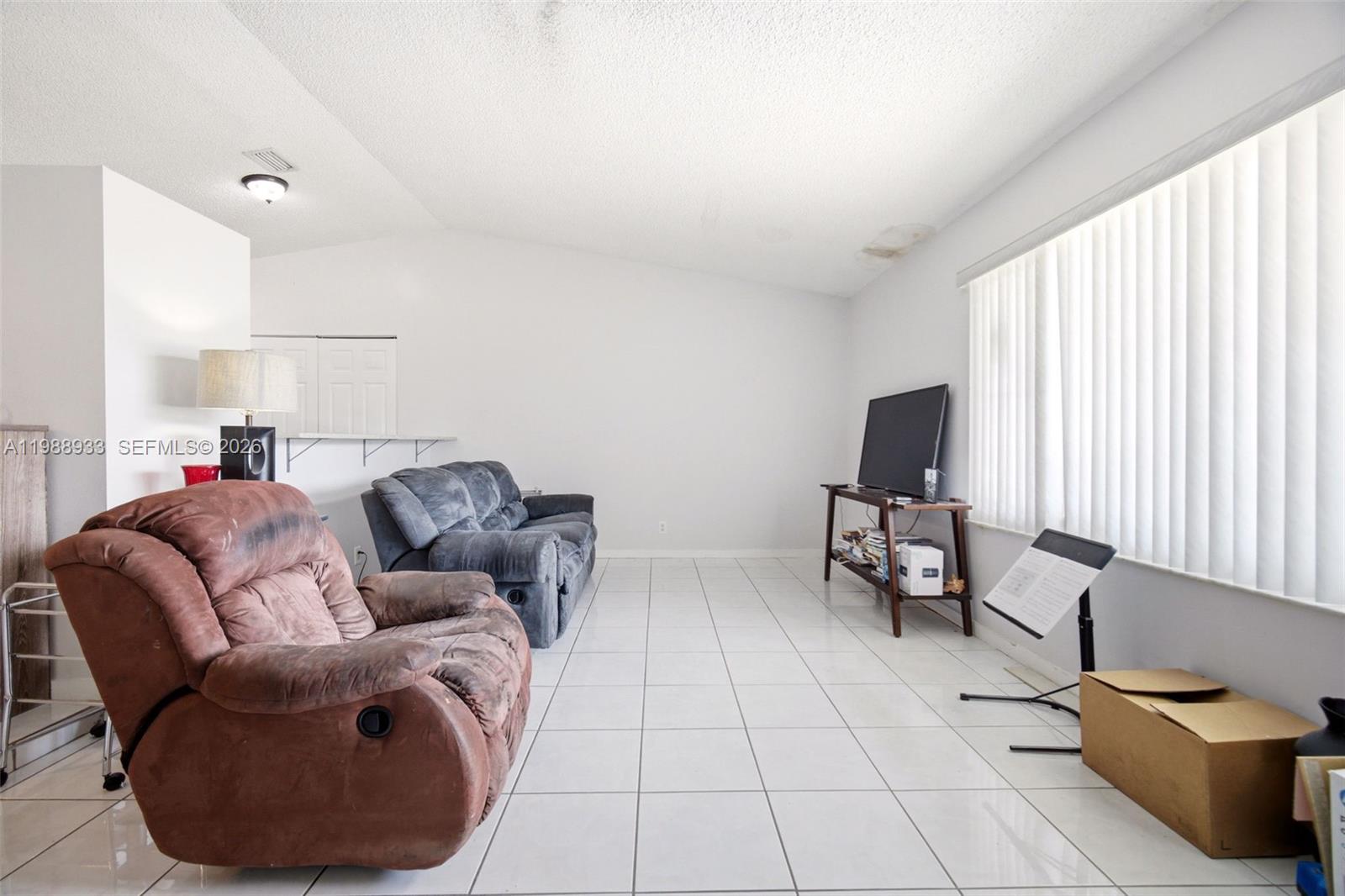 841 Southwest 55th Avenue Margate, FL 33068 - Photo 4 of 26 a living room with furniture and a flat screen tv