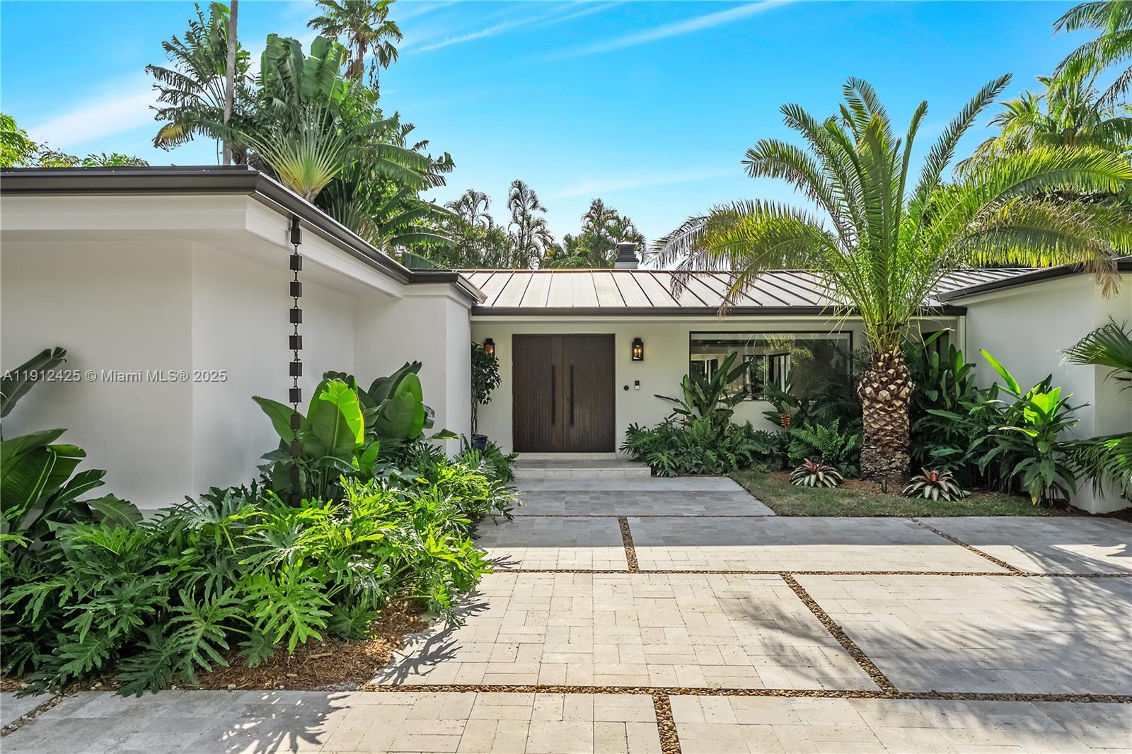 a front view of a house with a garden