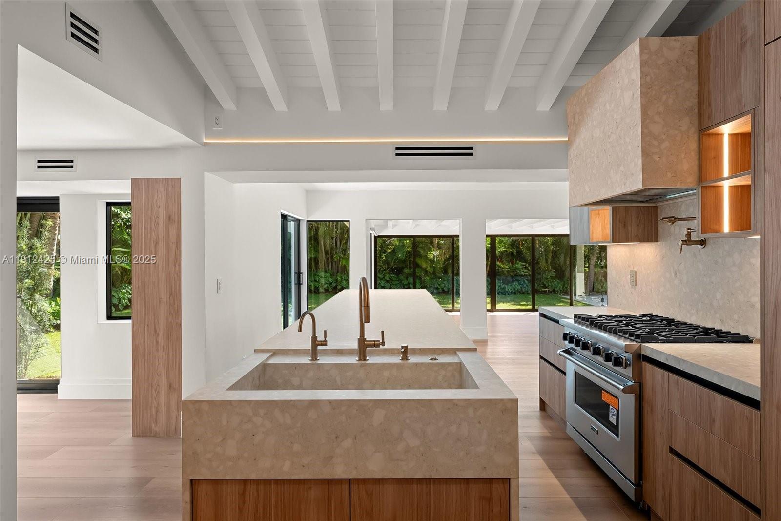 325 Gulf Road Key Biscayne, FL 33149 - Photo 11 of 51 a view of kitchen with kitchen island a stove and a large window