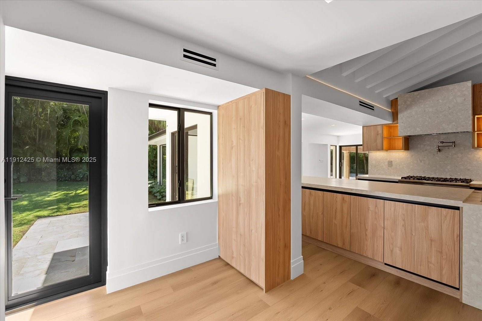 325 Gulf Road Key Biscayne, FL 33149 - Photo 14 of 51 a kitchen with granite countertop a refrigerator and a sink