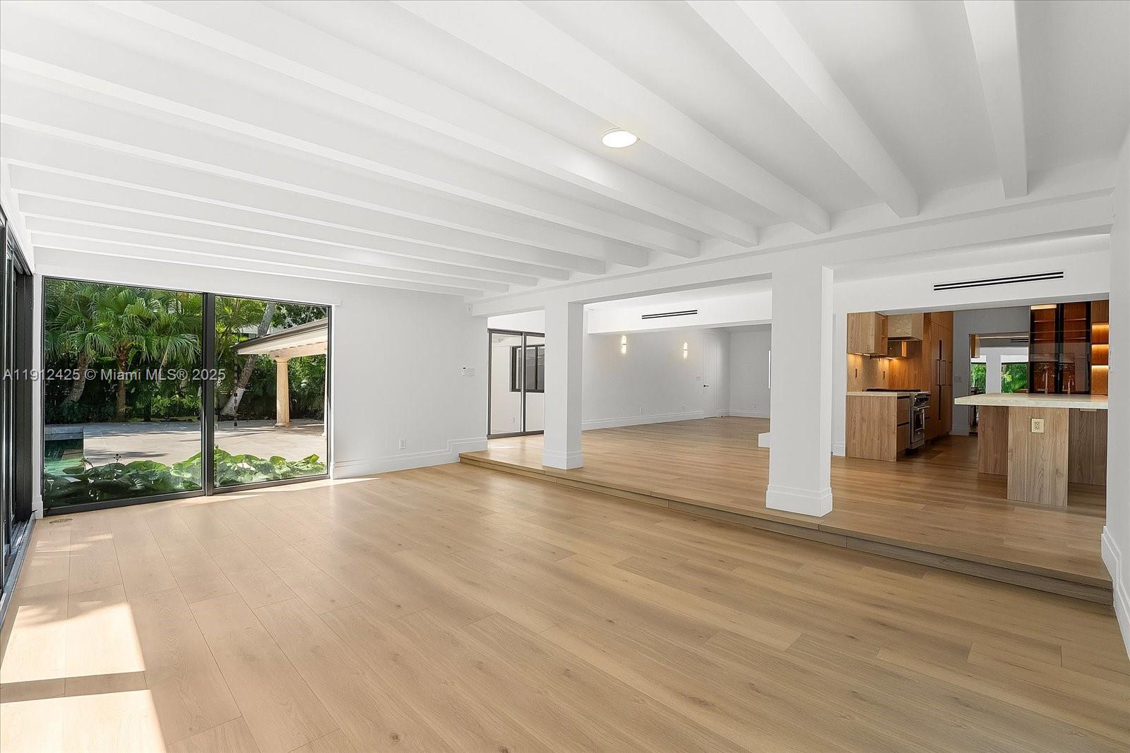 325 Gulf Road Key Biscayne, FL 33149 - Photo 15 of 51 a view of an empty room with wooden floor and a window