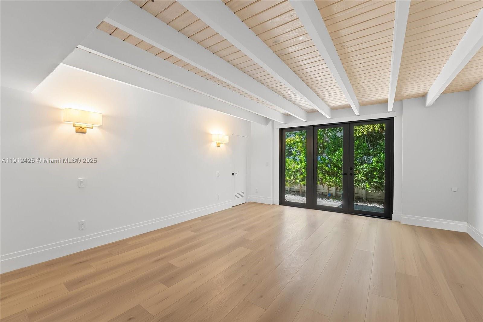 325 Gulf Road Key Biscayne, FL 33149 - Photo 19 of 51 an empty room with wooden floor and windows