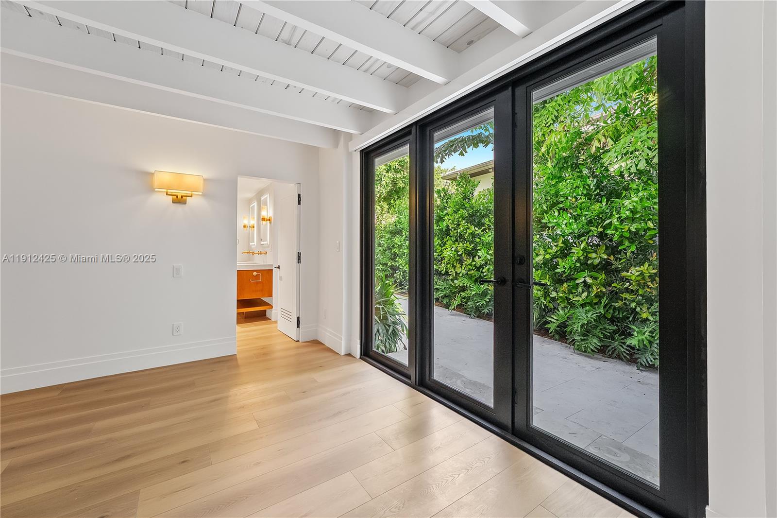 325 Gulf Road Key Biscayne, FL 33149 - Photo 20 of 51 a view of an empty room with wooden floor and a window
