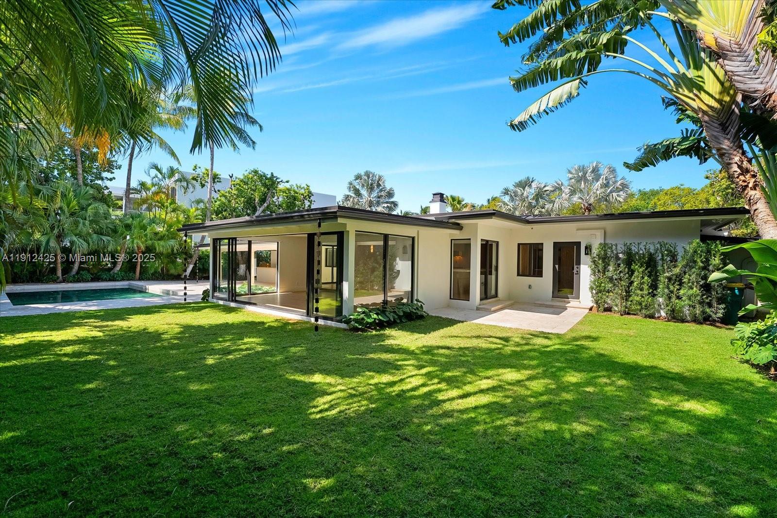 325 Gulf Road Key Biscayne, FL 33149 - Photo 2 of 51 a front view of house with yard and green space