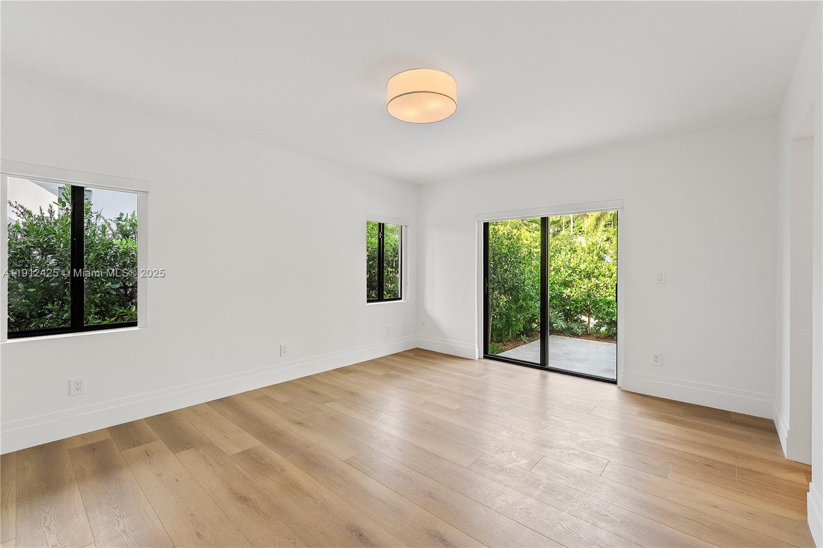 325 Gulf Road Key Biscayne, FL 33149 - Photo 26 of 51 an empty room with wooden floor and windows