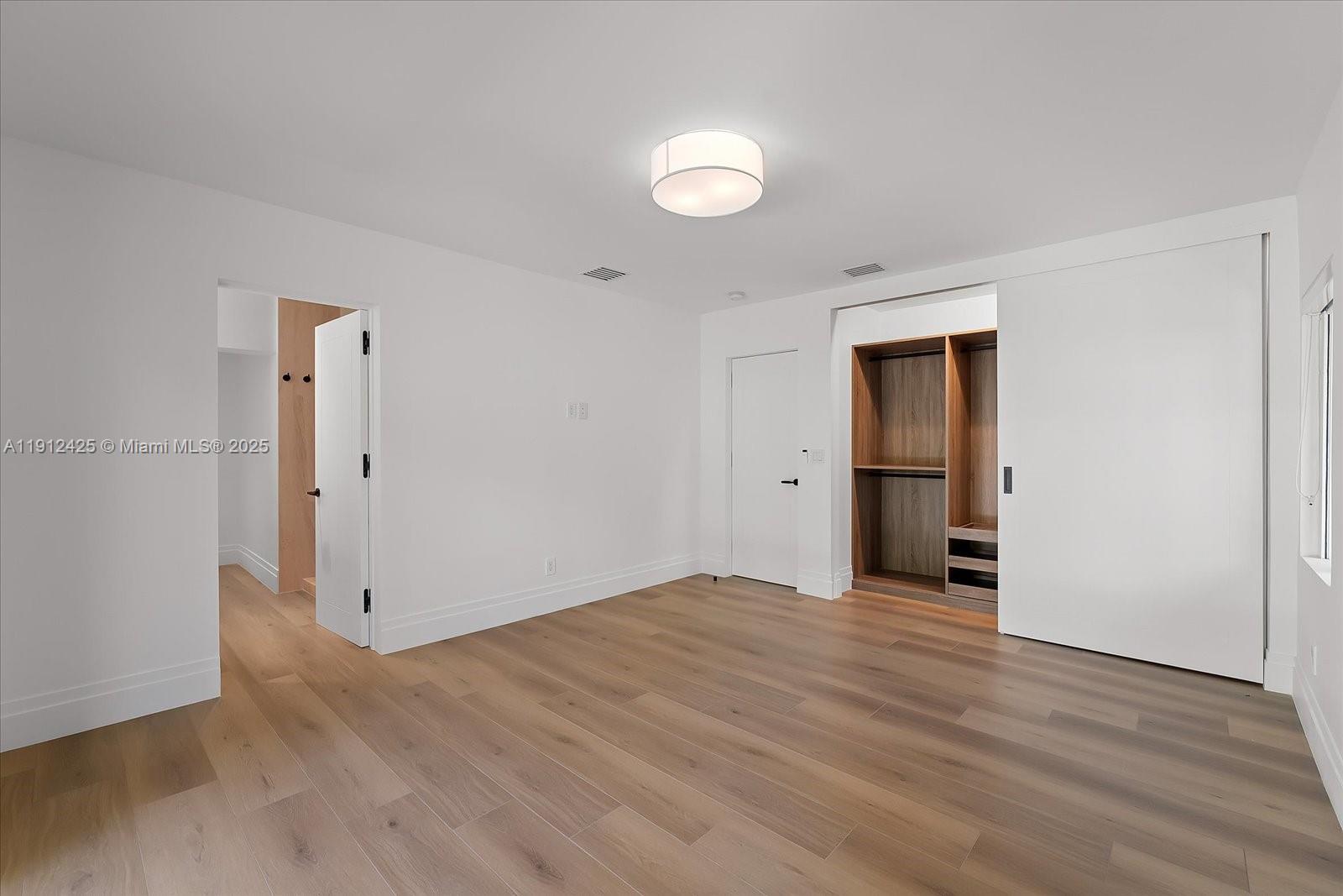 325 Gulf Road Key Biscayne, FL 33149 - Photo 29 of 51 an empty room with wooden floor and entrance