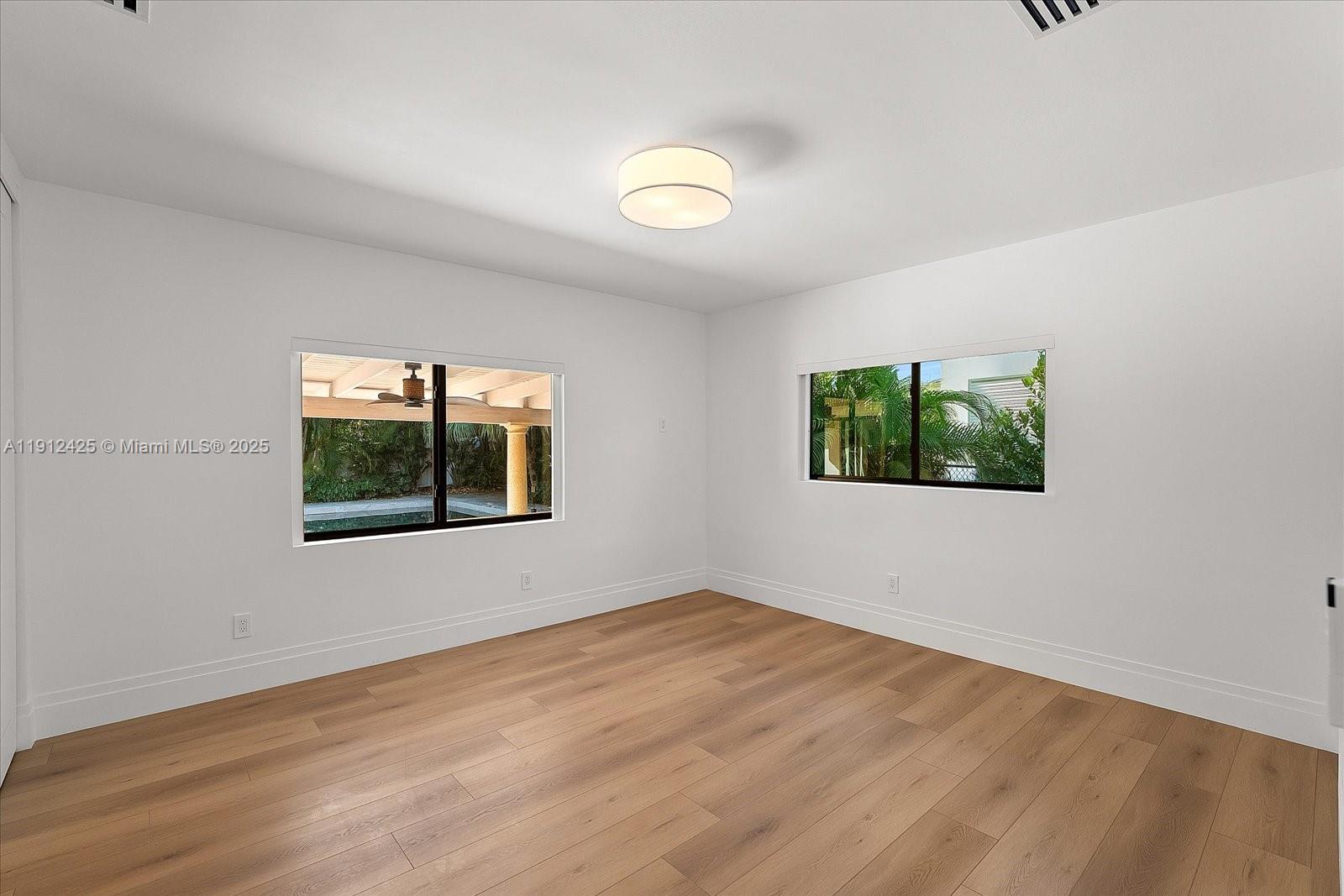 325 Gulf Road Key Biscayne, FL 33149 - Photo 34 of 51 a view of an empty room with wooden floor and a window