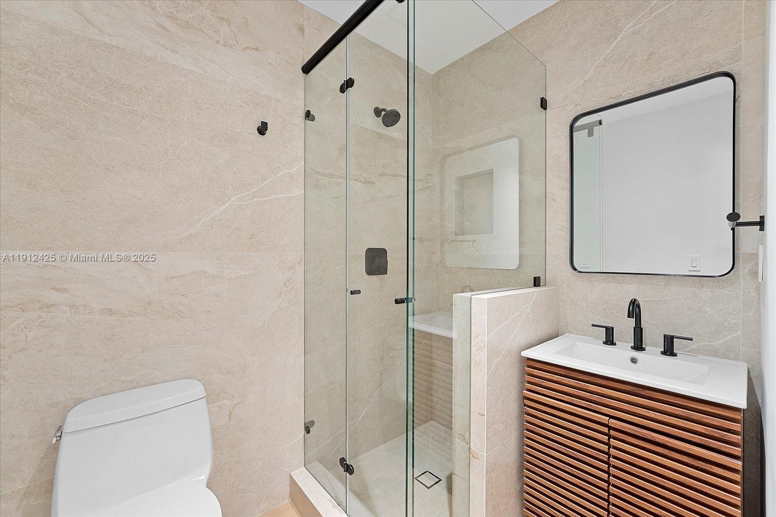 325 Gulf Road Key Biscayne, FL 33149 - Photo 40 of 51 a bathroom with a toilet a sink a mirror and shower