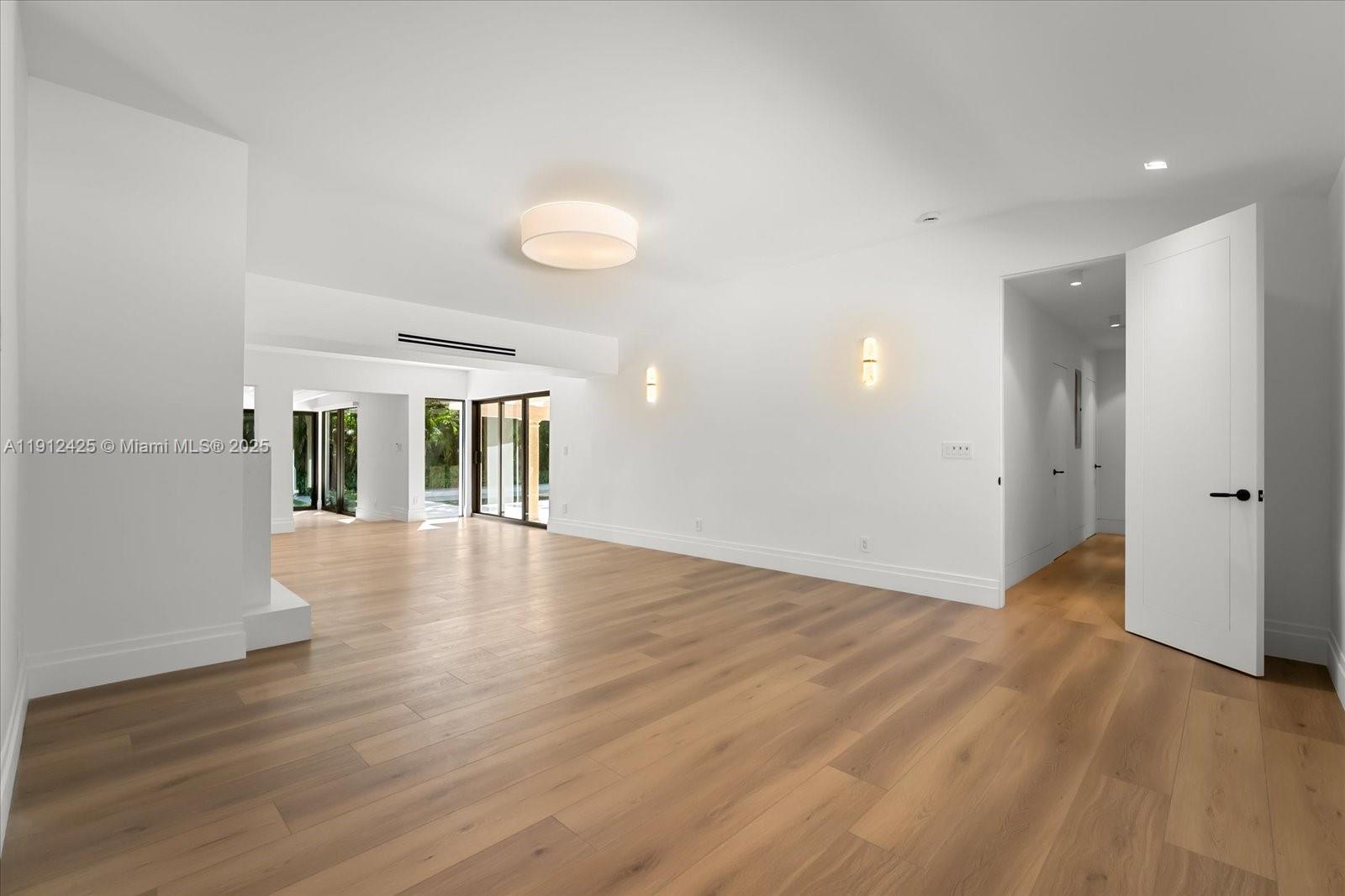 325 Gulf Road Key Biscayne, FL 33149 - Photo 4 of 51 a view of an empty room with wooden floor and a window