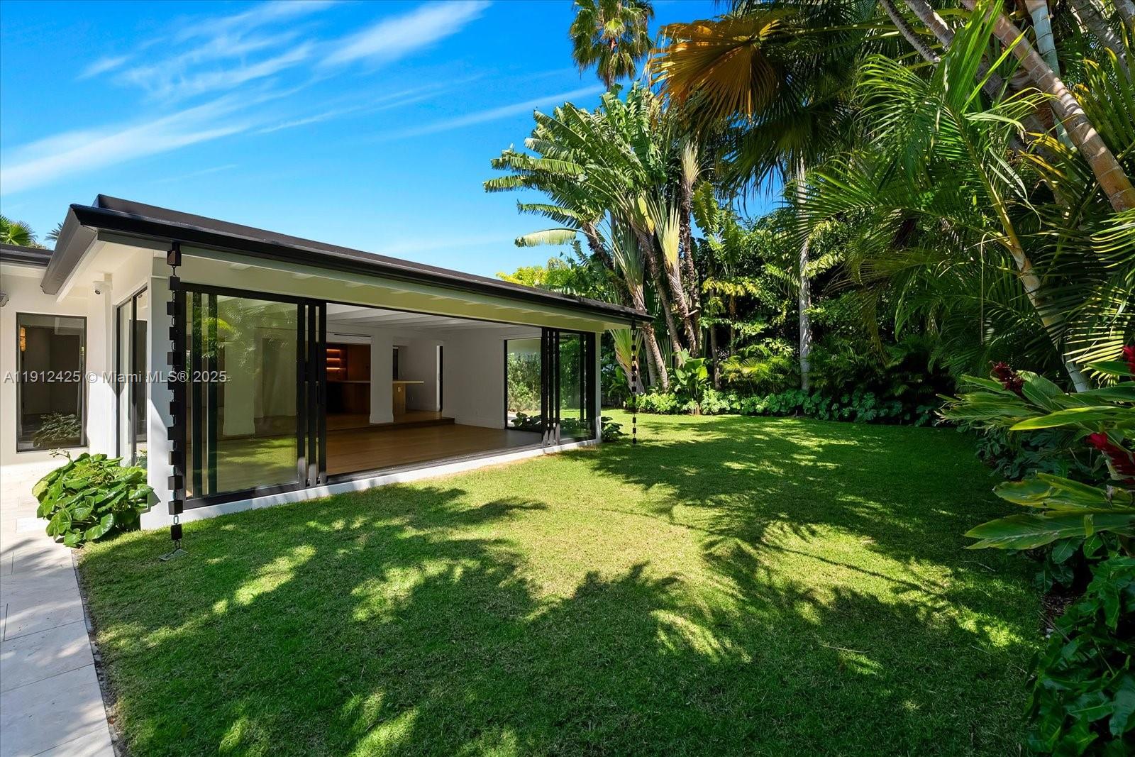 325 Gulf Road Key Biscayne, FL 33149 - Photo 44 of 51 a view of a house with a backyard