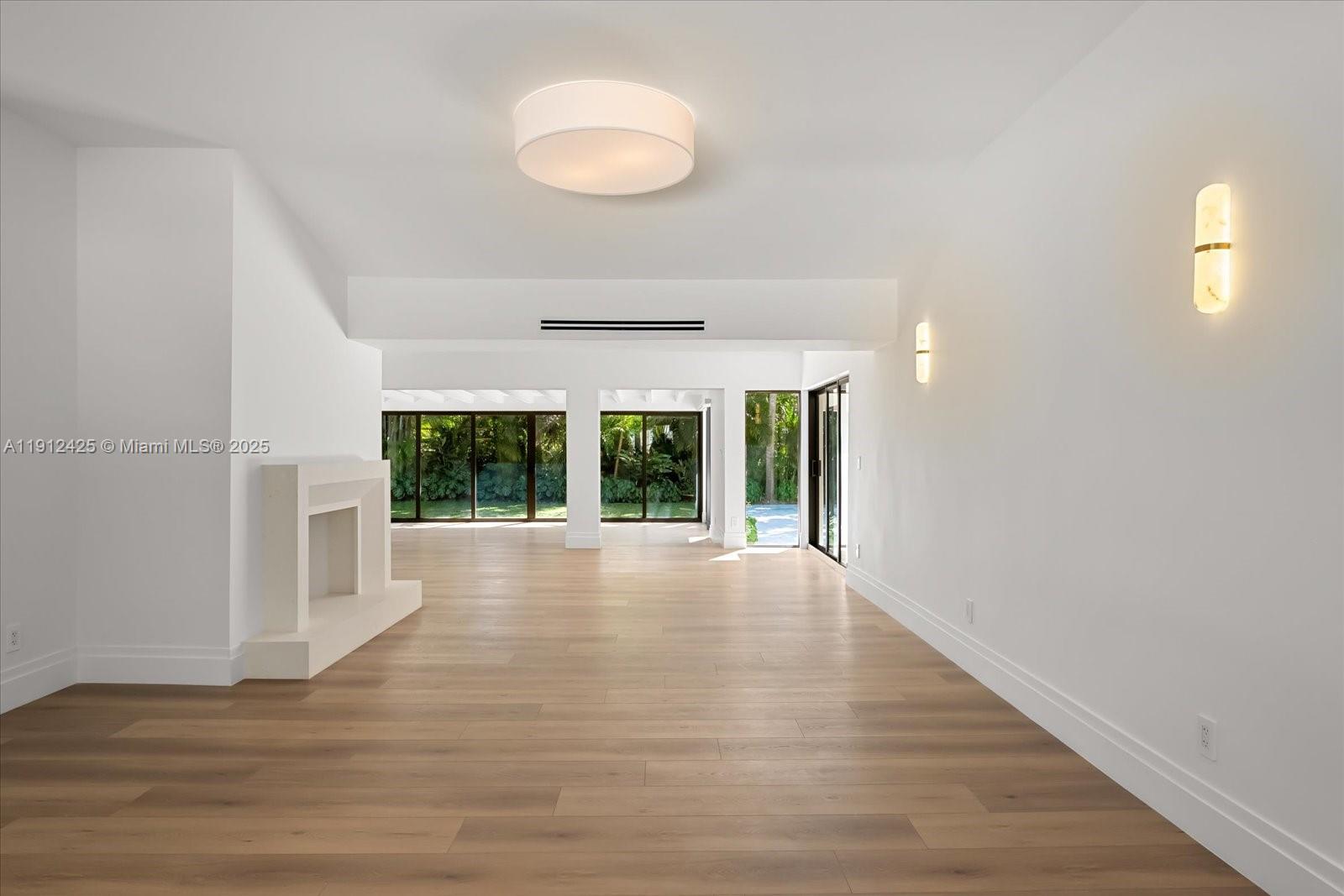 325 Gulf Road Key Biscayne, FL 33149 - Photo 5 of 51 a view of an empty room with wooden floor and a window