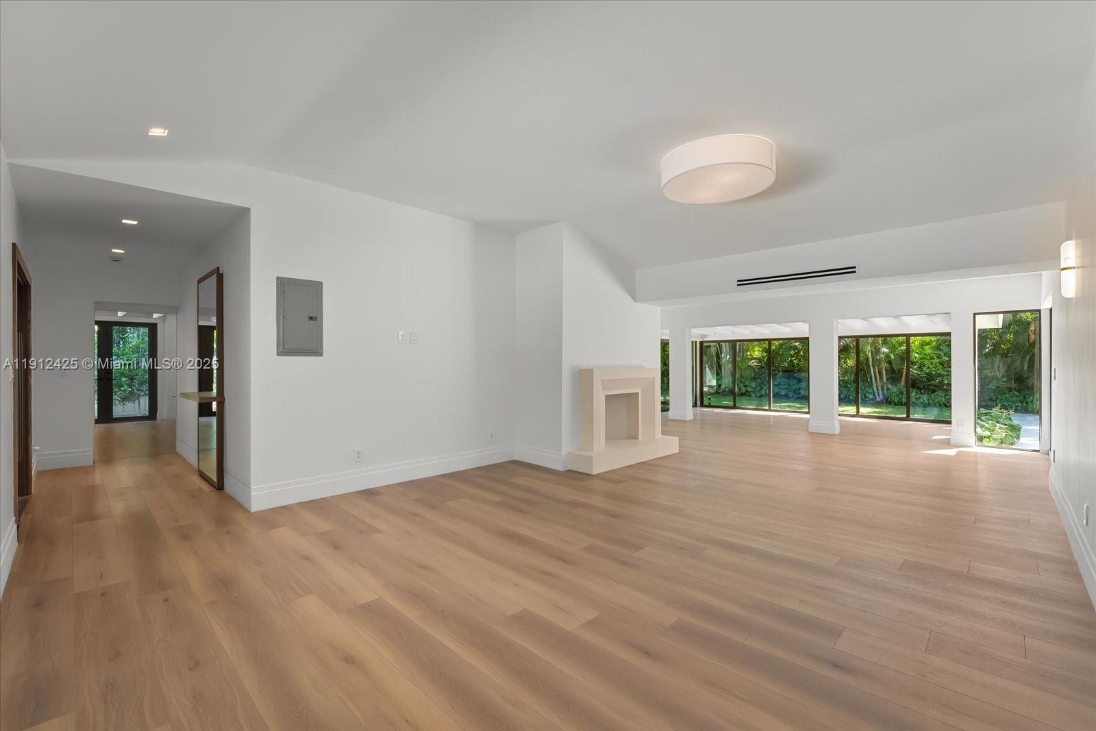 325 Gulf Road Key Biscayne, FL 33149 - Photo 6 of 51 a view of an empty room with wooden floor and a window