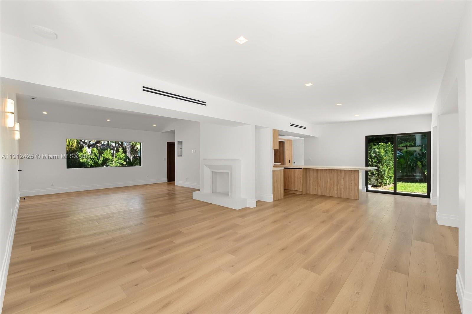 325 Gulf Road Key Biscayne, FL 33149 - Photo 7 of 51 a view of an empty room with wooden floor and a window