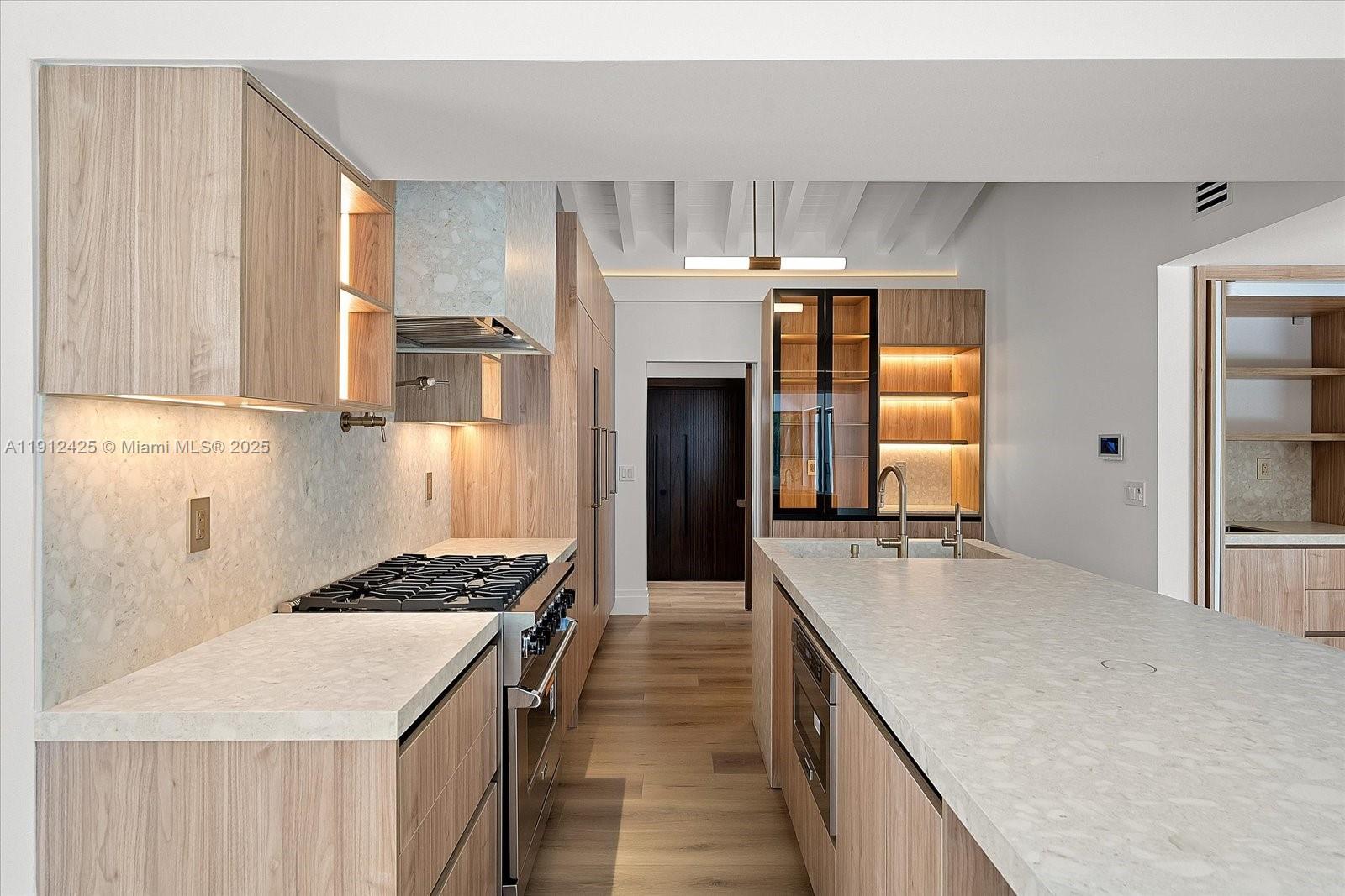 325 Gulf Road Key Biscayne, FL 33149 - Photo 10 of 51 a kitchen with a refrigerator and a sink