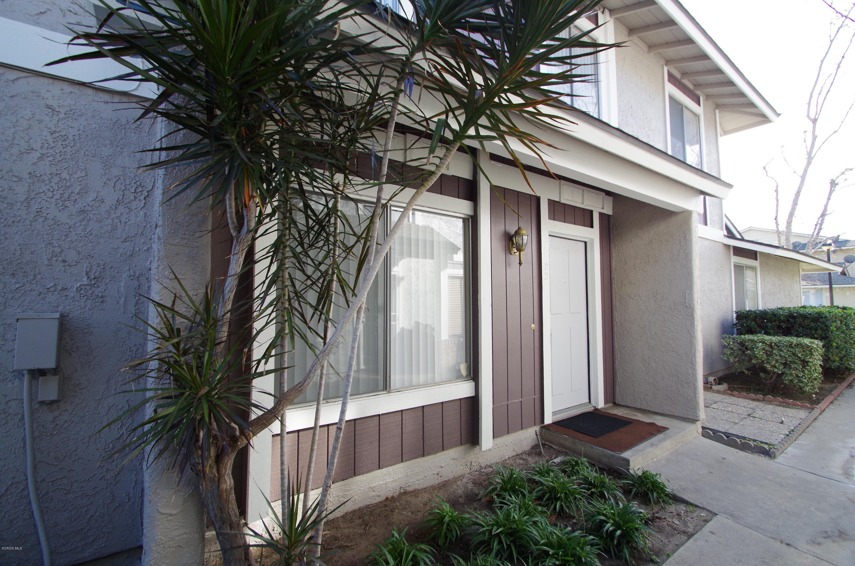 533 Spring Road, Unit 22 Moorpark, CA 93021 - Photo 1 of 20 a front view of a house with a yard