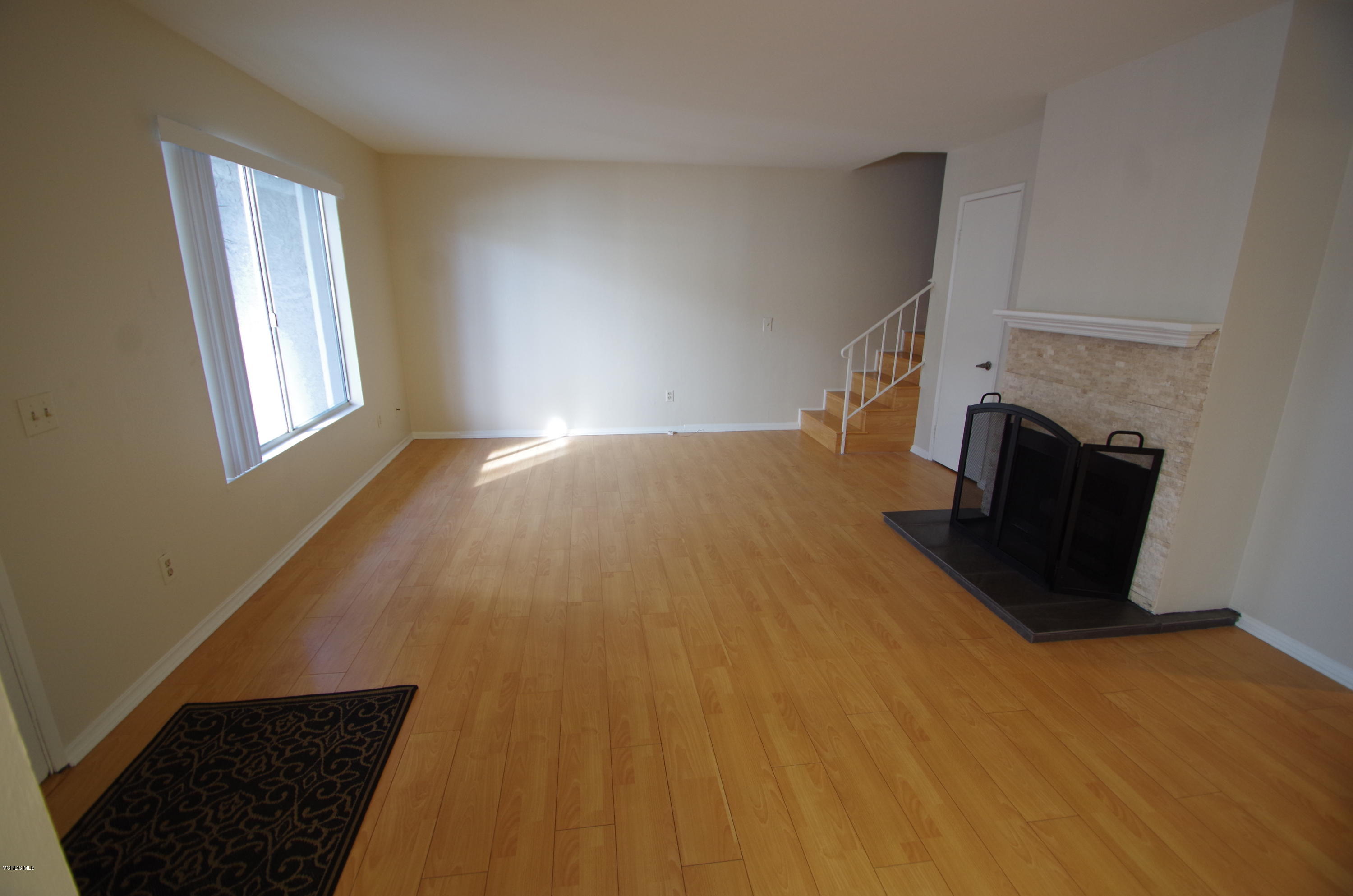 533 Spring Road, Unit 22 Moorpark, CA 93021 - Photo 3 of 20 a view of an empty room and window with wooden floor