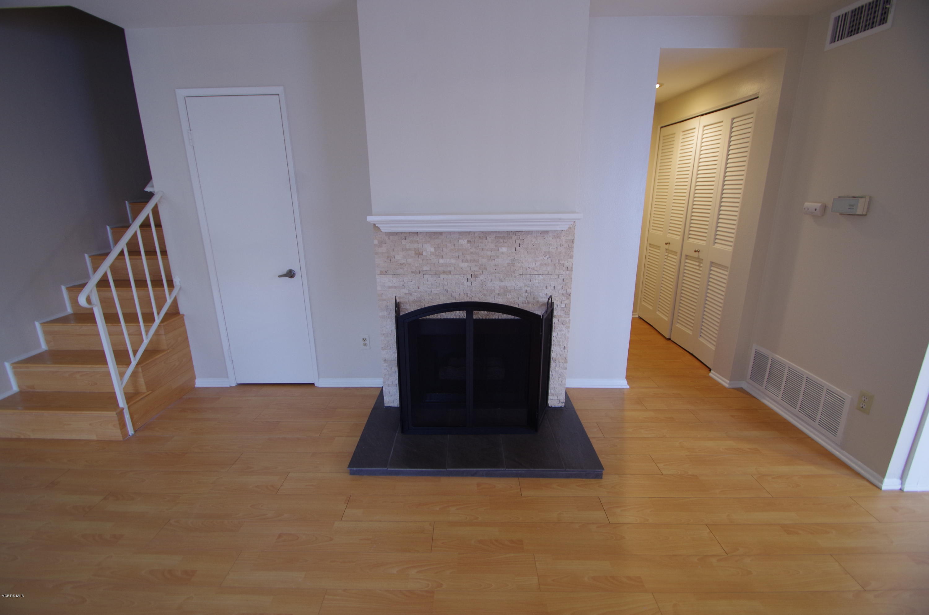 533 Spring Road, Unit 22 Moorpark, CA 93021 - Photo 4 of 20 a view of an empty room with wooden floor and a window
