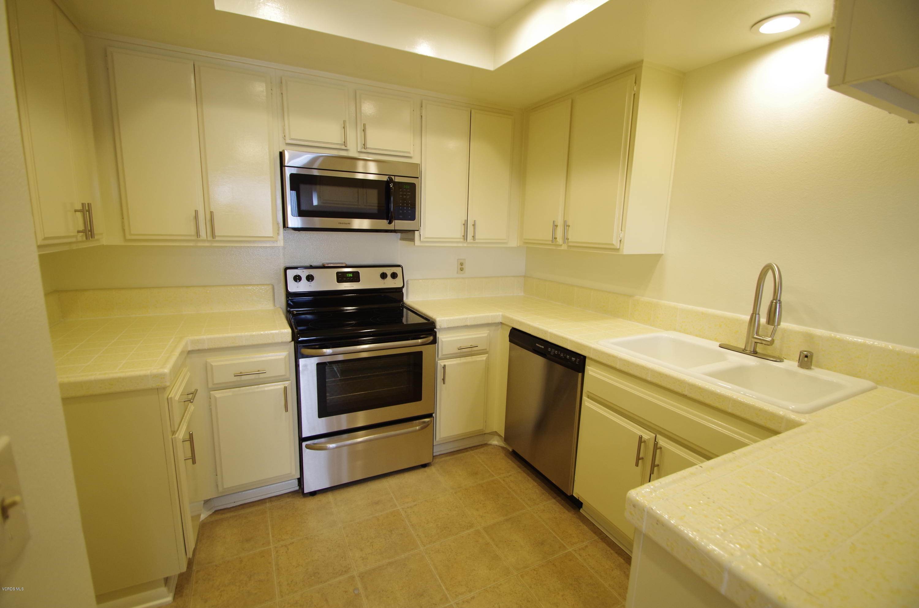 533 Spring Road, Unit 22 Moorpark, CA 93021 - Photo 6 of 20 a kitchen with a sink and a stove top oven