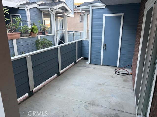 21901 Moneta Avenue, Unit 49 Carson, CA 90745 - Photo 8 of 9 an empty room with wooden floor and windows