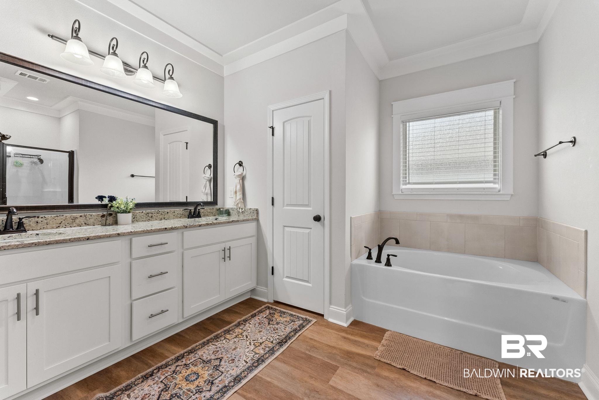 10745 Brodick Loop Daphne, AL 36527 - Photo 21 of 39 Full bath featuring double vanity, crown molding, light wood-style floors, a bath, and a shower stall