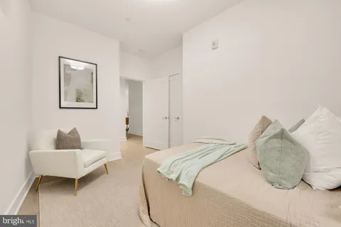 a bedroom with a bed and a couch