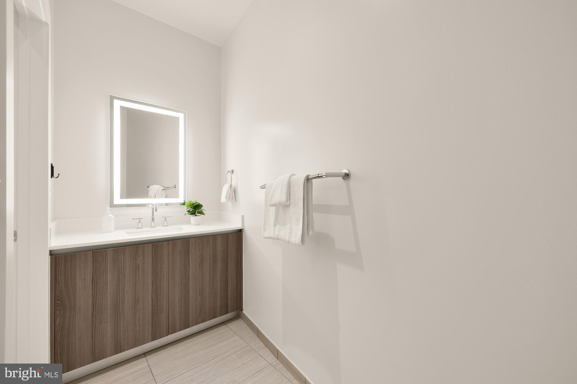 1745 N Street Northwest, Unit 104 Washington, DC 20036 - Photo 25 of 28 a bathroom with a sink and mirror
