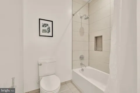 a bathroom with a toilet and bathtub