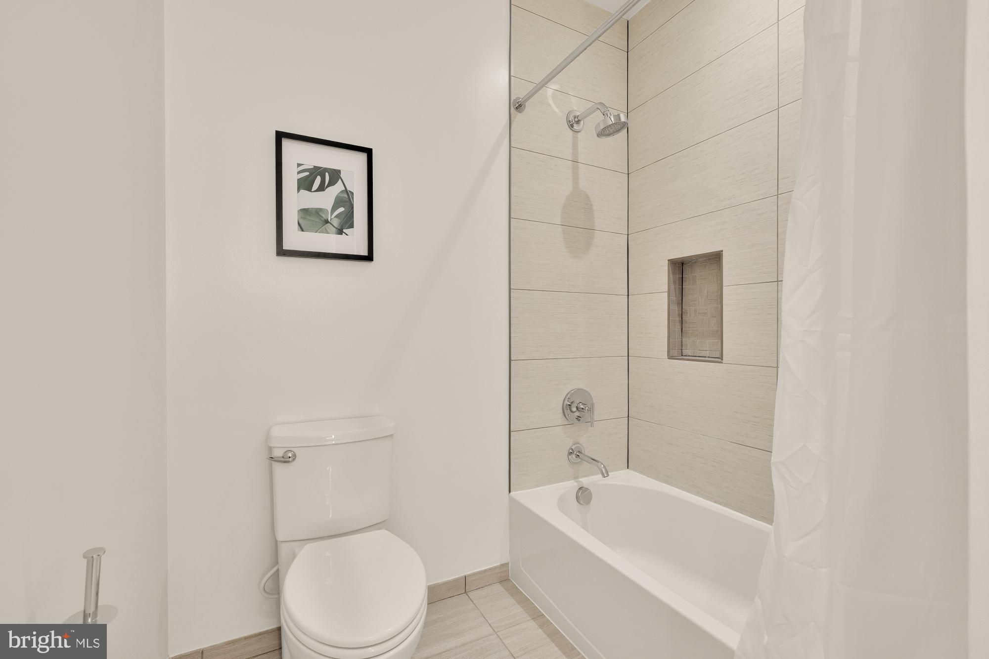 1745 N Street Northwest, Unit 104 Washington, DC 20036 - Photo 26 of 28 a bathroom with a toilet and bathtub